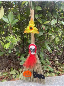 Halloween witch broom decoration party prop with skull and pumpkin design for spooky events.
