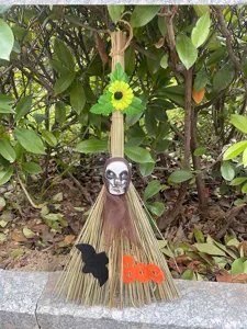 Halloween witch broom decoration prop with skull bat and Boo sign for spooky party festival display.