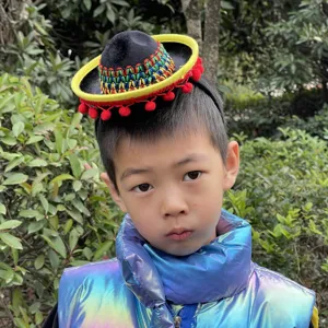 Mexican mini sombrero headband with colorful woven details and red pom poms for party.