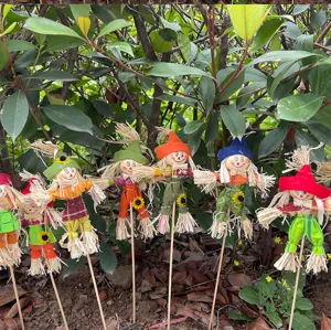 Detailed view of colorful scarecrow garden stakes outdoors, perfect for autumn yard decoration.