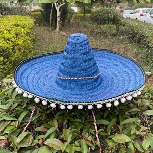 Blue Mexican straw hat with white pom poms and colorful braided string for fiesta party.