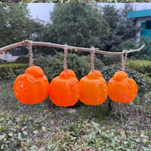 Halloween pumpkin hanging light detail showcasing orange lighted decor piece for festive party.