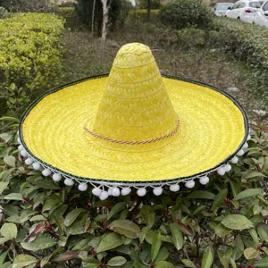 Yellow Mexican straw sombrero hat with colorful braided rope and pom pom trims main view