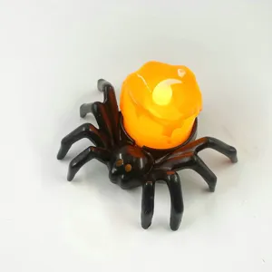 Halloween LED electronic candle light with black spider base, glowing orange wax decoration for party.