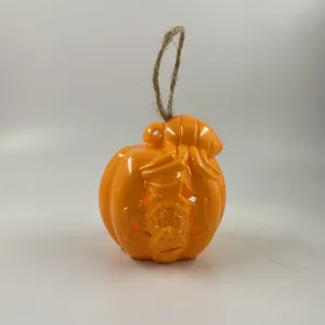 Halloween orange pumpkin hanging decoration with spider web and rope for party decor.