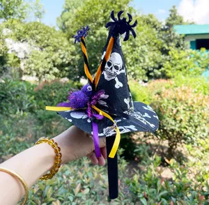 Close-up detail of the Halloween witch hat headband with skull print and plush spider decor.