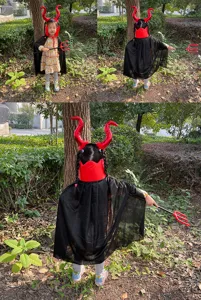 Detail shot of children's Halloween devil costume set featuring red horns, black cape and pitchfork.