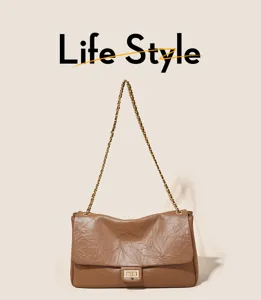 Brown vintage chain shoulder bag detail featuring classic flap and metal turn lock closure.