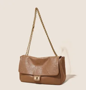 Vintage style women leather shoulder bag with chain strap and classic turn-lock design.