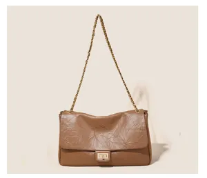 Vintage brown shoulder bag with gold chain strap and turn-lock closure for women daily use.