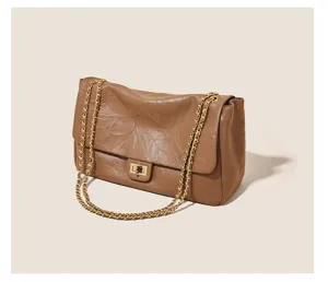 Vintage brown leather shoulder bag with metal chain strap and turn-lock closure for women.