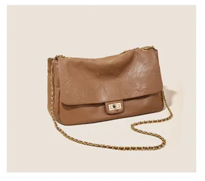 Vintage brown leather shoulder bag with chic chain strap and metal turn lock for women.