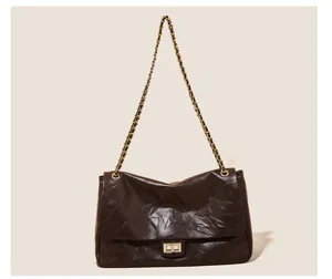 Dark brown vintage quilted shoulder bag with gold chain strap and chic turn lock detail.