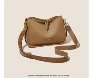 Detailed view of the stylish taupe soft leather shoulder bag with gold-tone hardware.