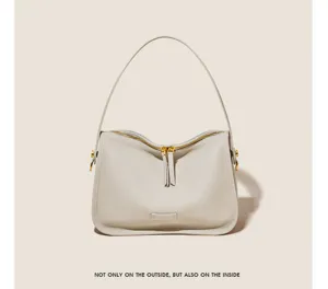 Detailed view of soft leather shoulder bag with smooth zipper and elegant metal hardware.
