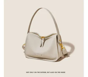 Minimalist soft leather shoulder bag with gold-tone hardware for women everyday style.