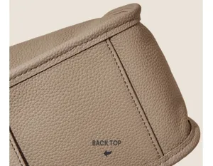 Detailed view of the premium soft leather handbag, showcasing exquisite stitching and texture.