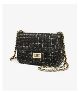 Black tweed crossbody bag with gold chain strap, elegant flap design and chic metal lock.