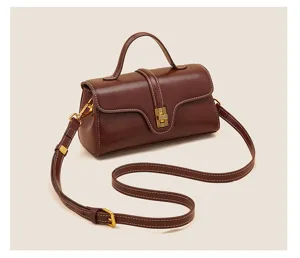 Premium genuine leather crossbody handbag with top handle, elegant design and wide strap.