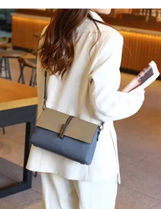 Stylish two-tone leather crossbody shoulder bag for women, trendy multi-compartment design.