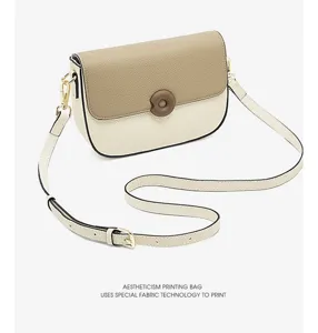 Two-tone leather saddle bag detail, featuring adjustable strap and metallic hardware.