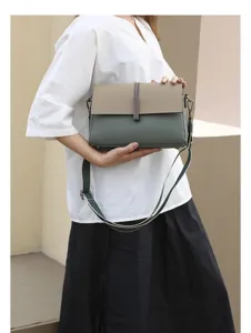 Genuine leather color-block crossbody bag with adjustable strap and chic flap design.