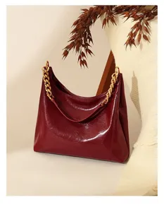 Burgundy patent leather shoulder bag, large capacity underarm hobo with gold chains.