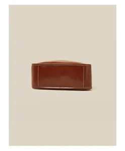 Detailed view of brown leather bag bottom showing premium stitching and durable structural design.