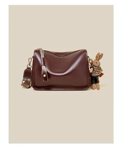 Retro brown women shoulder crossbody bag detail with cute plush bunny charm and ethnic strap.