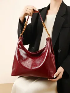 Elegant red hobo shoulder bag for women, luxury design with chunky gold chain handle.