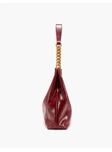 Red patent leather shoulder bag side detail, elegant hobo underarm purse with chunky gold chain.