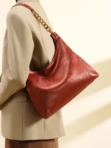 Elegant red hobo shoulder bag with chic chain strap and subtle embossed pattern for women.