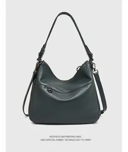 Detailed view of the dark grey leather hobo shoulder bag featuring front zipper pocket hardware.