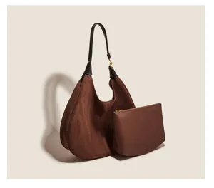 Detail view of retro brown suede shoulder hobo bag with pouch, showing fine texture.