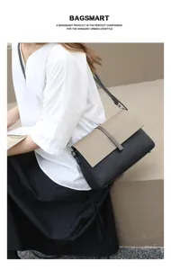 Two-tone leather crossbody bag detail shot, featuring a chic khaki flap and black body with lock.
