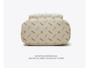Detailed view of beige monogram fashion backpack featuring special fabric printing technology.