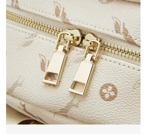 Close-up detail of women casual backpack featuring durable beige leather and shiny gold zippers.