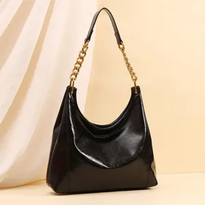 Elegant black leather hobo shoulder bag with luxury gold chain strap for women daily use.