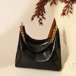 Black chic shoulder hobo bag featuring a chunky gold chain strap for daily fashionable wear.