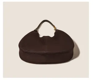 Retro brown suede hobo shoulder bag detail, elegant crescent shape with metallic hardware.