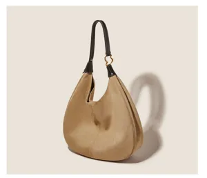 Detailed view of the khaki suede hobo shoulder bag with dark brown leather strap and ring.