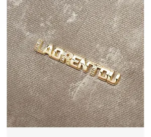 Close-up van het metalen strass-logo op een stijlvolle schoudertas van satijn.