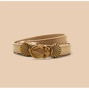 Gedetailleerd overzicht van smalle dames leren riem met vintage schelp gesp voor jurken en jassen.