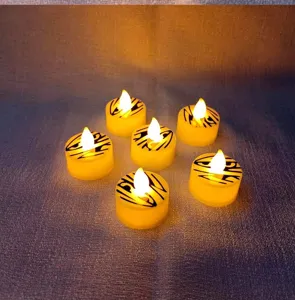 Halloween LED tea light candles with mummy wrap pattern, warm glow for party decor.