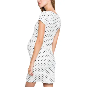 Close-up detail view showing the side ruched design and classic polka dot pattern on maternity dress.