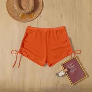 Orange mesh swim shorts for women, high waist beach bottoms with cute side drawstring details.