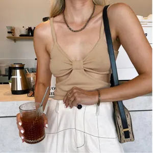 Chic beige knit camisole featuring a front bow cutout design, slim fit, and backless style for women.