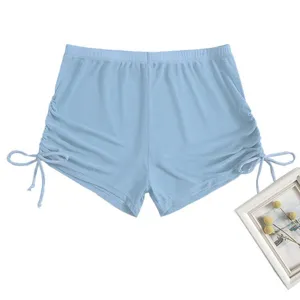 Close-up detail of light blue high-waist women bikini bottom with side drawstring ruching.