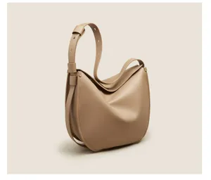 Soft leather slouchy shoulder bag detail, elegant curved shape and fine texture for daily wear.