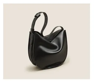Detail view of the black soft leather crescent shoulder bag, showing smooth curve.